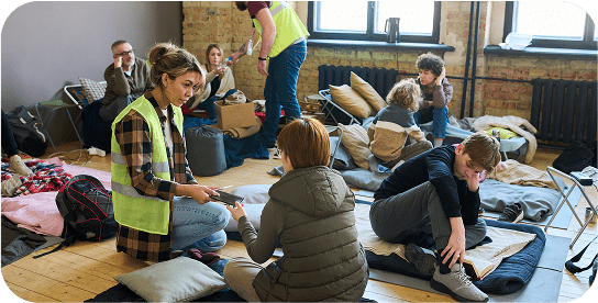 People gathered in a community shelter room.