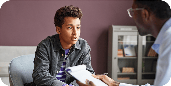 Teen in conversation with a professional.