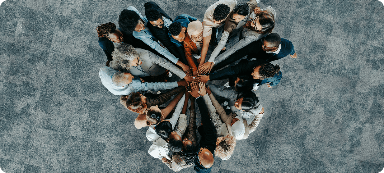 Diverse group forming a united circle.
