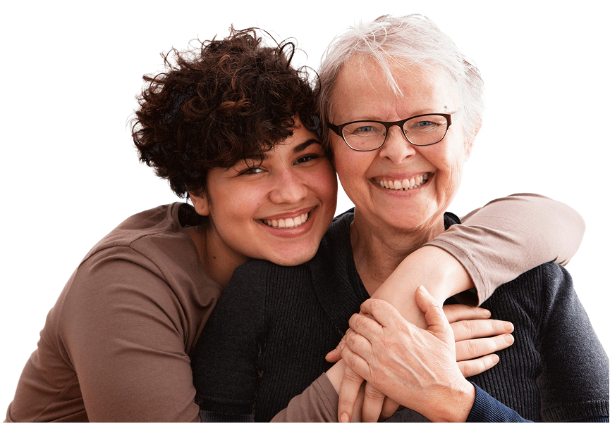 Smiling woman hugging elderly woman closely.